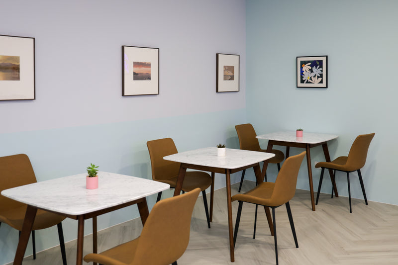 This photo shows our hot desks closest to the artwork. Sitting near the walls provides a greater sense of privacy and peace, hence people's preference for those seats.