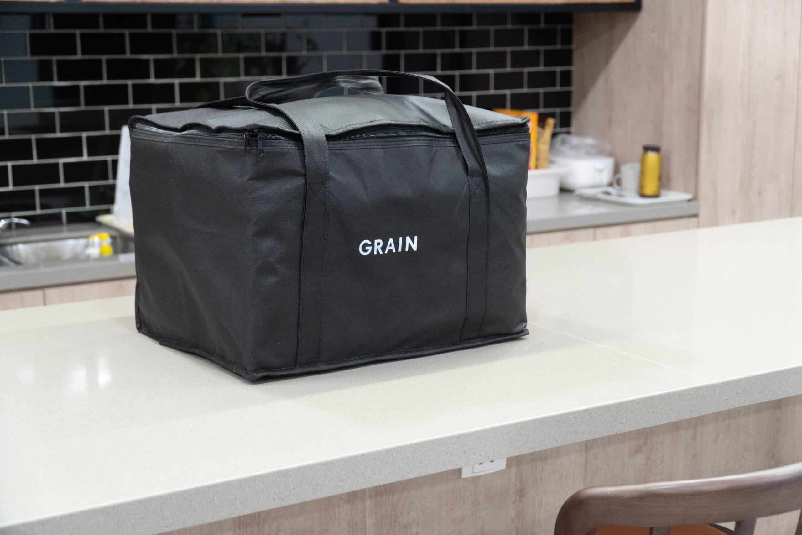 CoWorkSpace Security Bag Black security bag labeled "GRAIN" on a white countertop at CoWorkSpace CBD.