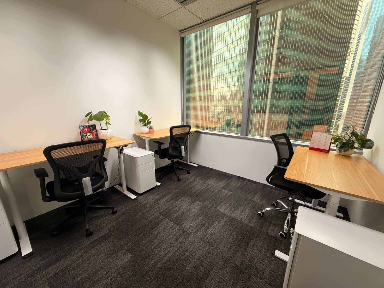 CoWorkSpace Singapore Office Modern coworking office with desks and chairs in a high-rise building.