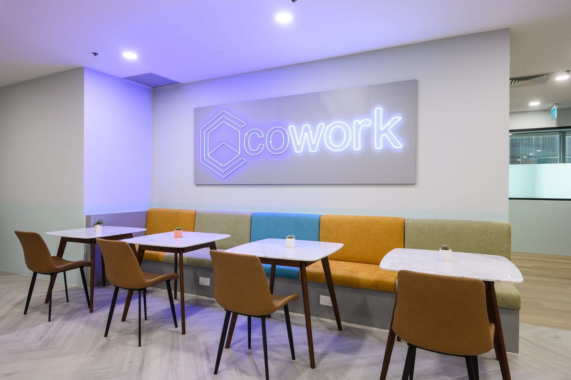 CoWorkSpace Modern Lounge Modern coworking lounge with seating and neon sign at CoWorkSpace.