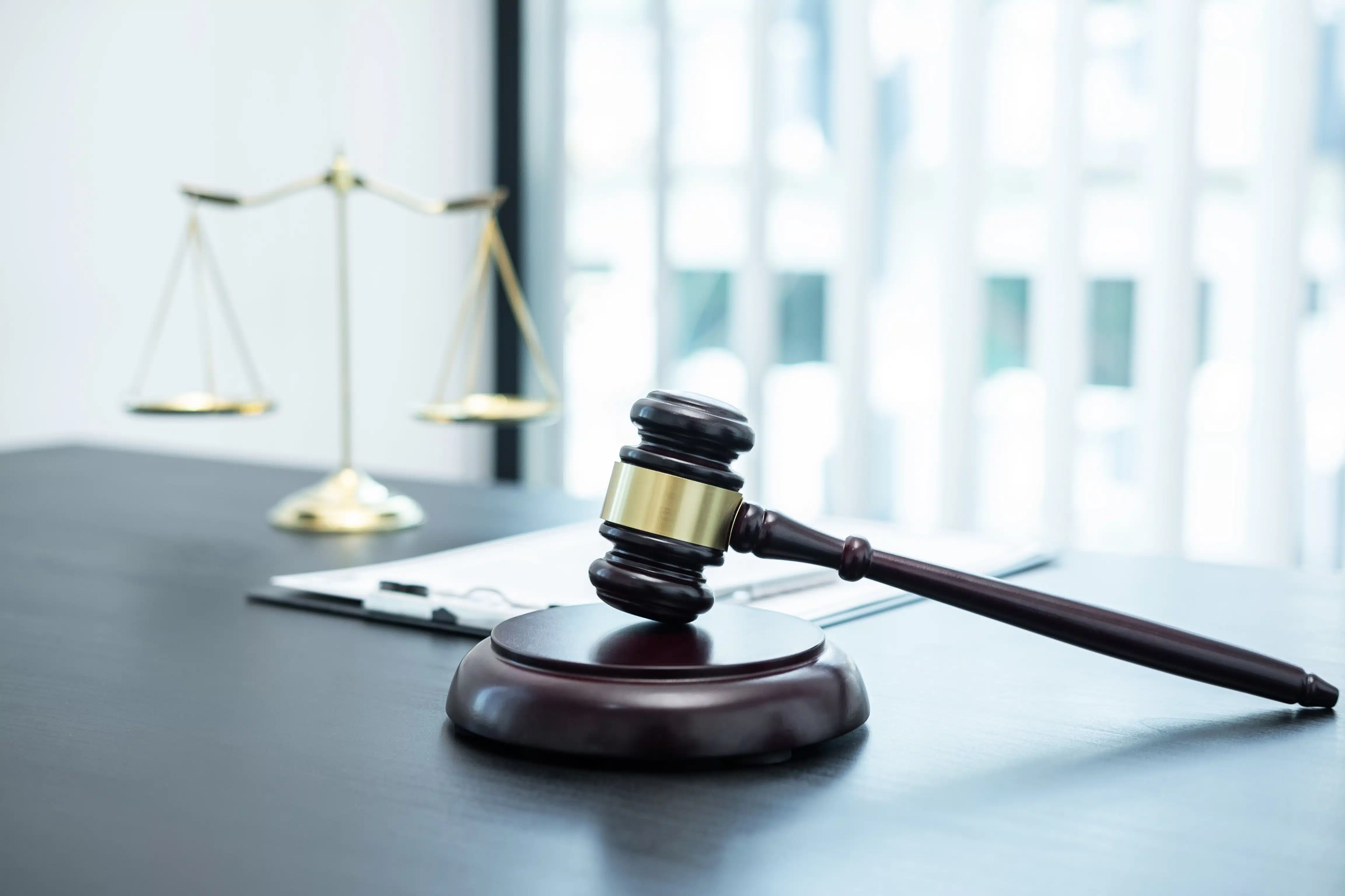 Gavel and scales of justice on a desk, symbolising legal services at CoWorkSpace in Singapore.