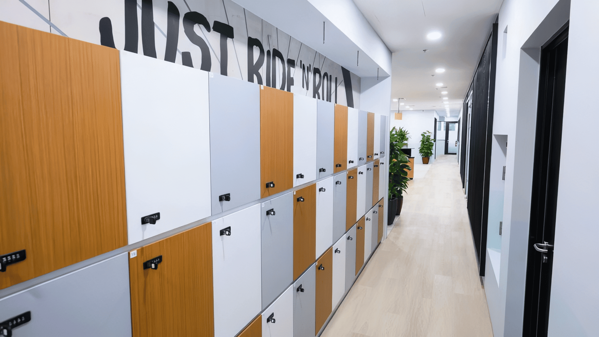 Lockers in a contemporary coworking space with wooden and white finishes at CoWorkSpace Singapore.