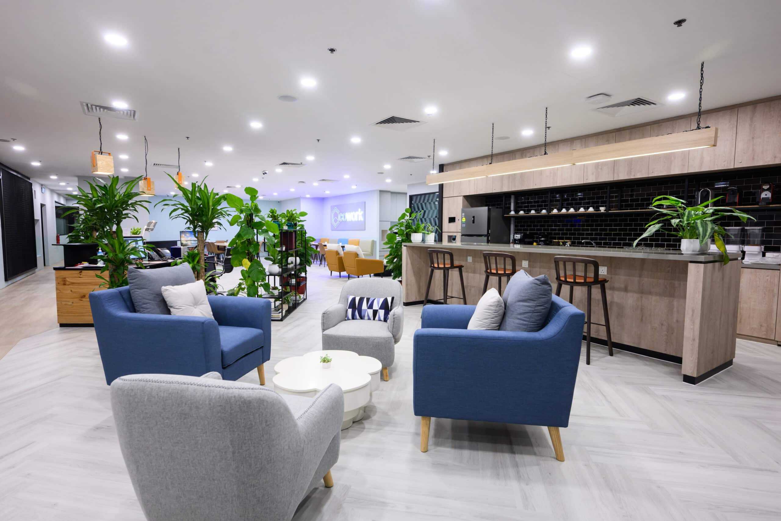 Contemporary coworking lounge with comfortable seating and greenery.
