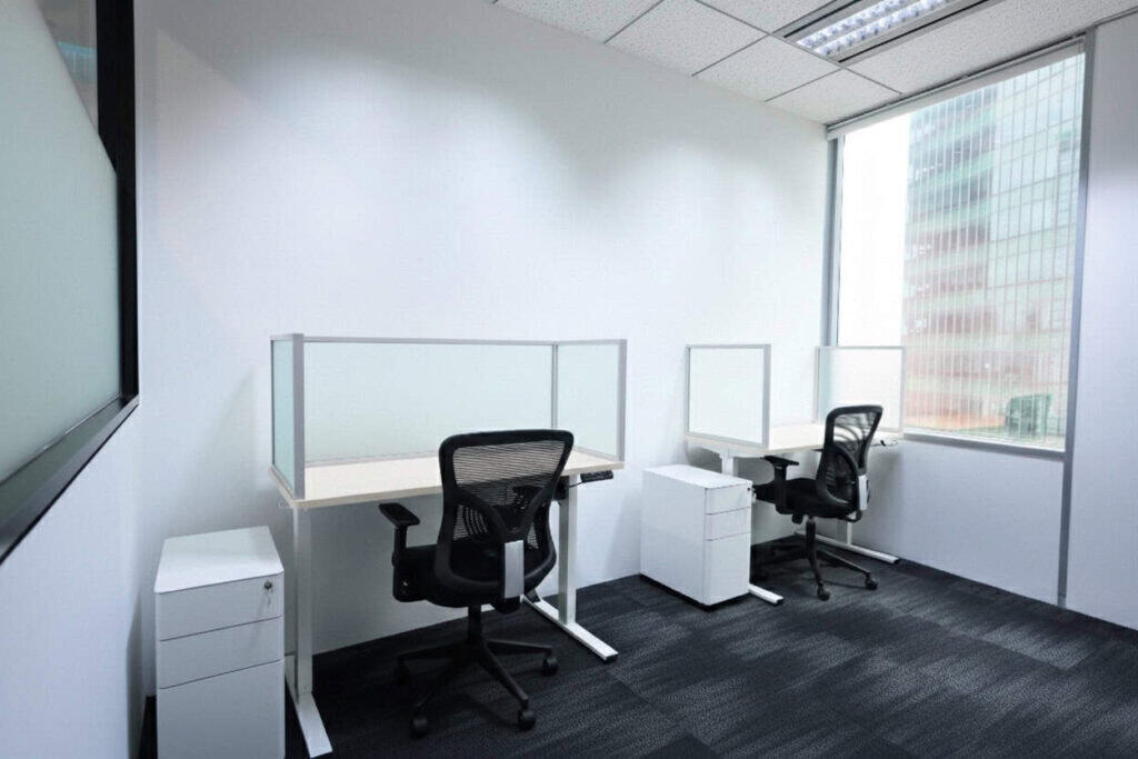 Working from Home Versus Our Coworking Spaces: A Serviced Office Solution in Raffles Quay for Executive Productivity 3 Modern co-working office with desks and chairs in Singapore.