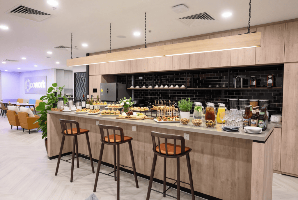 Contemporary coworking space featuring a refreshment bar, ideal for building business relationships.
