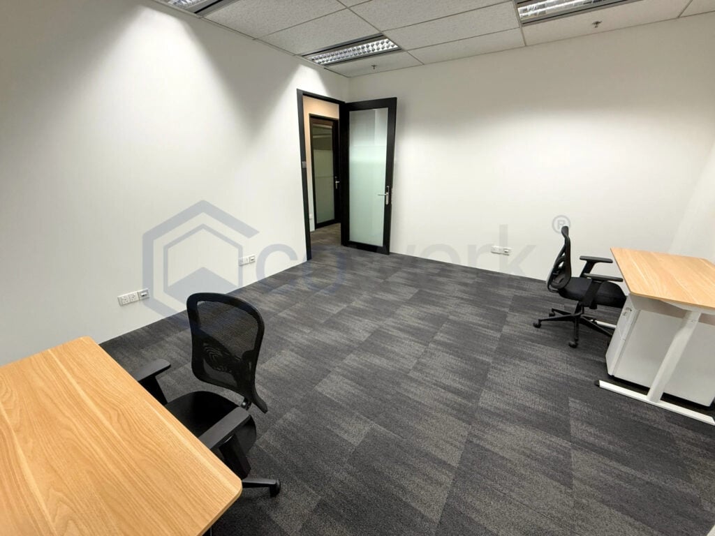 Empty modern office room with desks and chairs at CoWorkSpace Singapore.