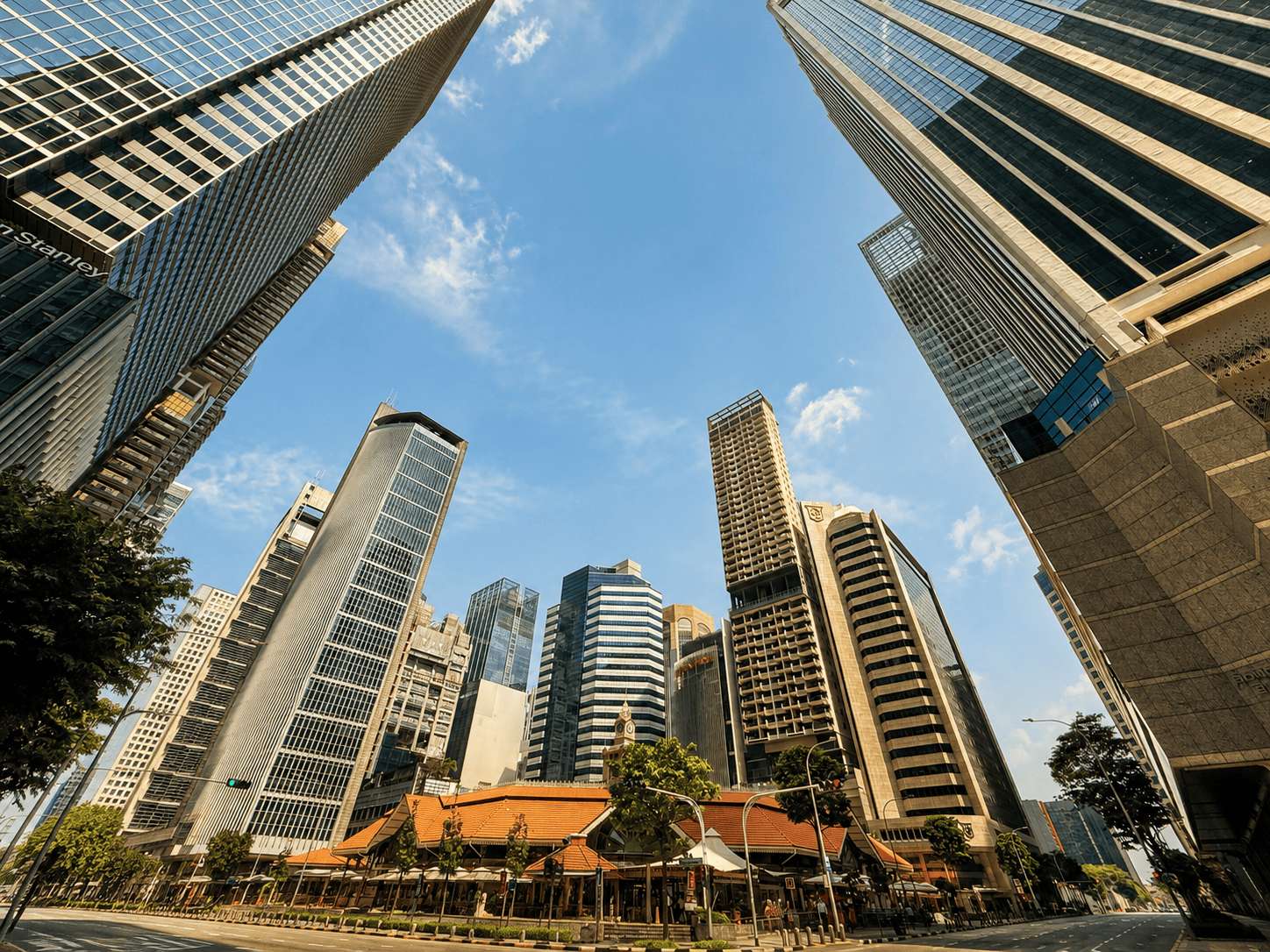 Buildings around Lau Pa Sat Singapore city skyline with modern skyscrapers and blue sky.
