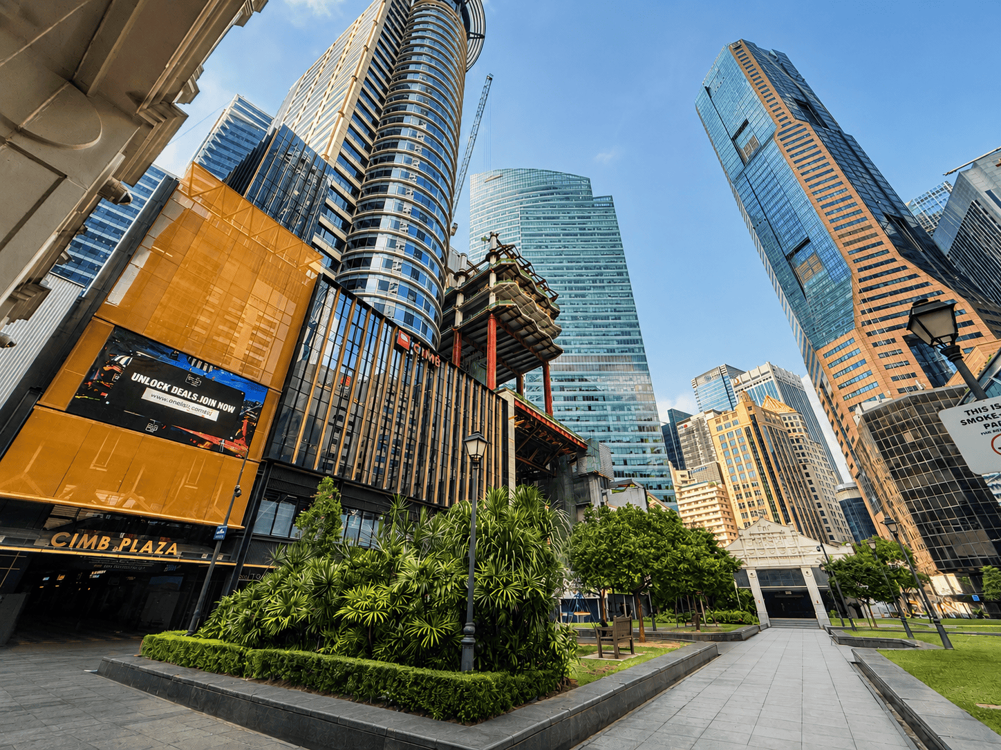 Modern Singapore cityscape with skyscrapers and green park area.