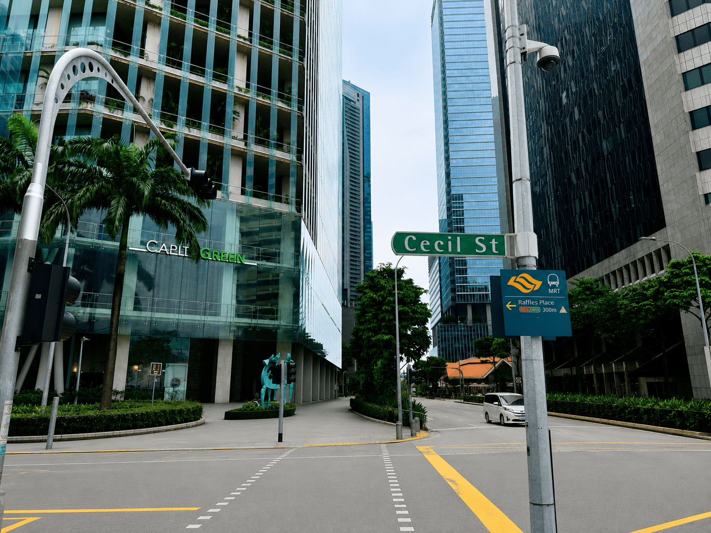 City street view with modern skyscrapers and street signs in Singapore.