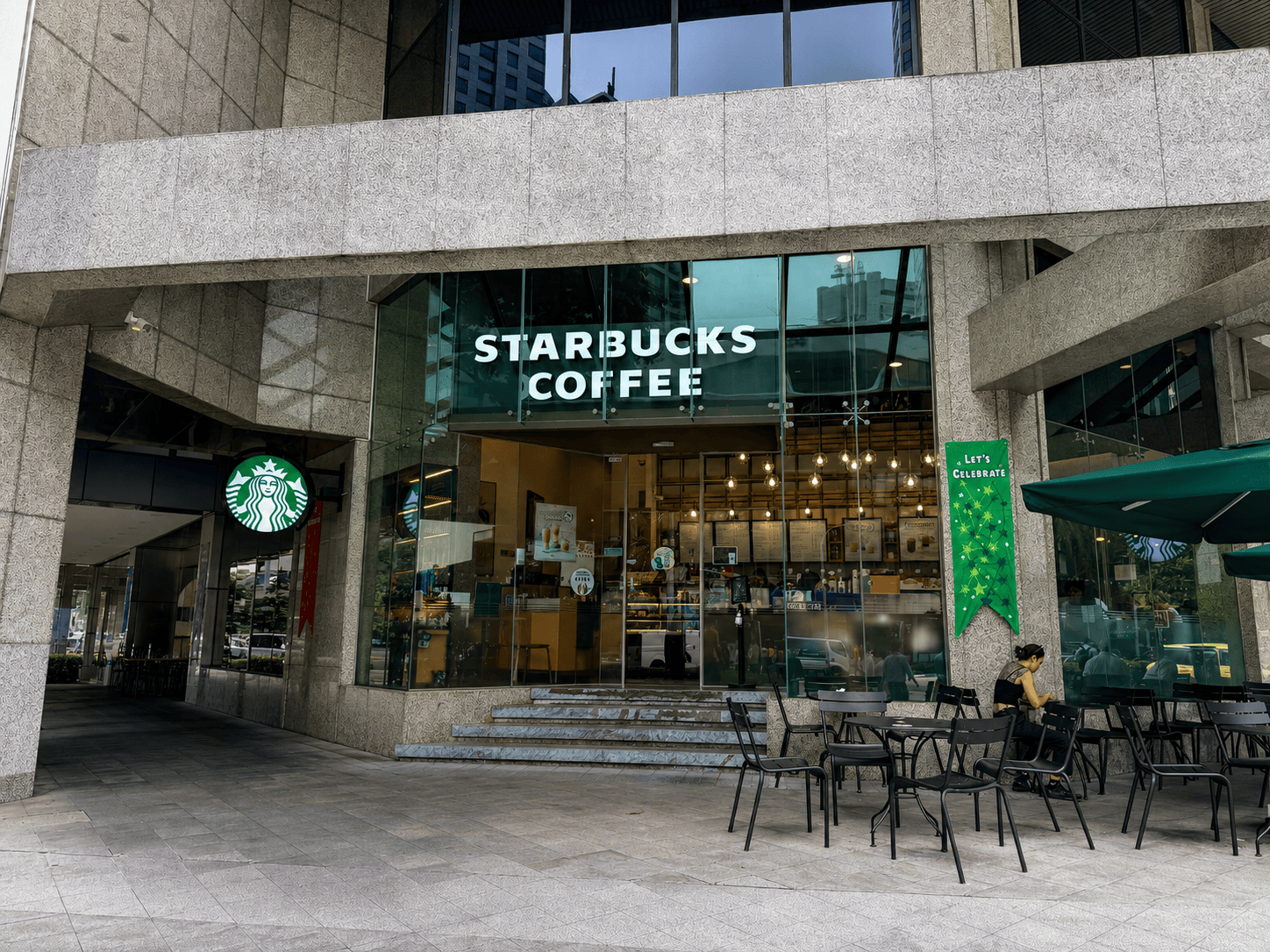 City house starbucks Office buildings in a busy urban area with high-rise glass towers.