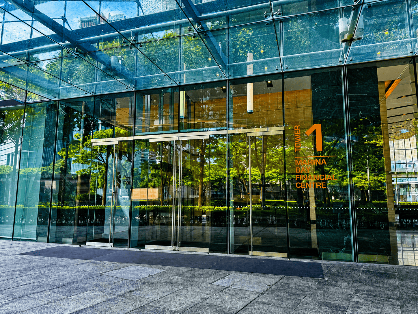 Modern office building entrance with signage for Centre, Financial, Bay, and Marina areas.