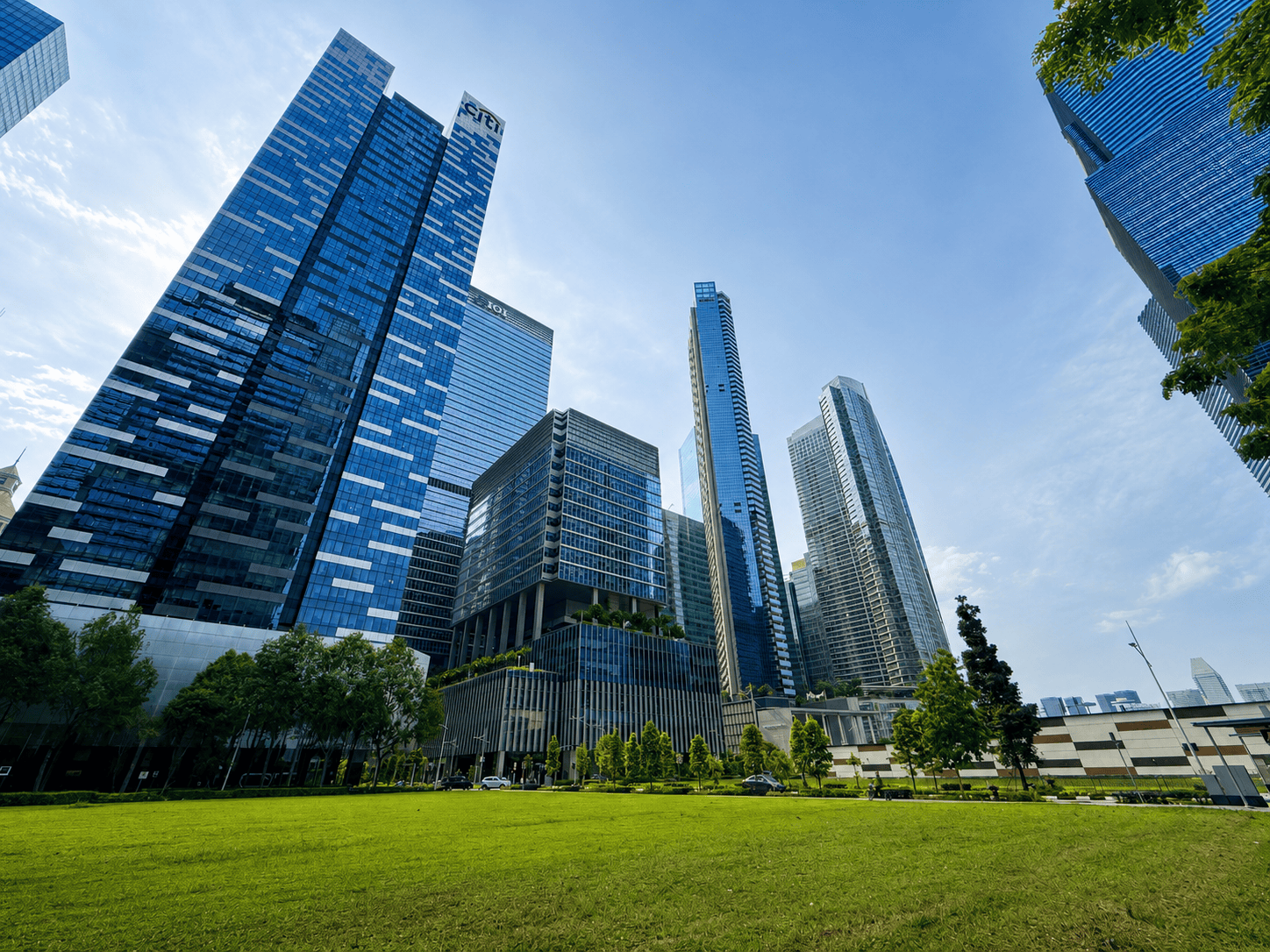 Office Buildings Shenton Way Modern skyscrapers in a business district with green park in foreground.