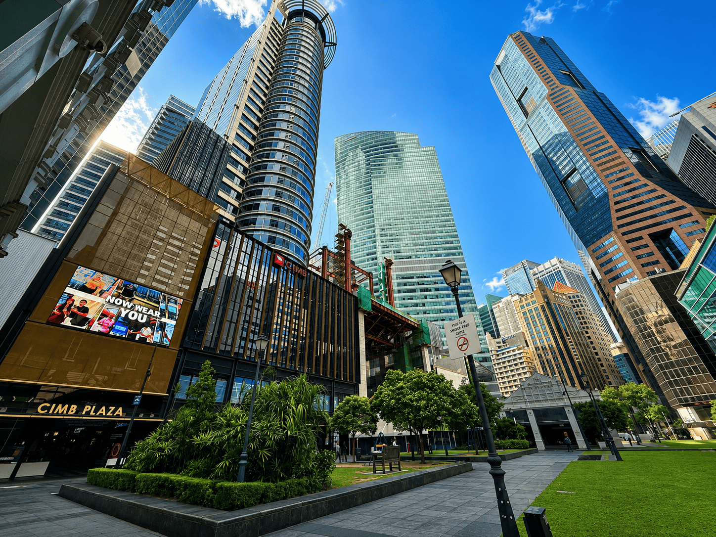 Raffles Place-CIMB Plaza Modern cityscape with skyscrapers and green park in the foreground.